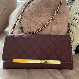 A maroon STEVE MADDEN Clutch bag